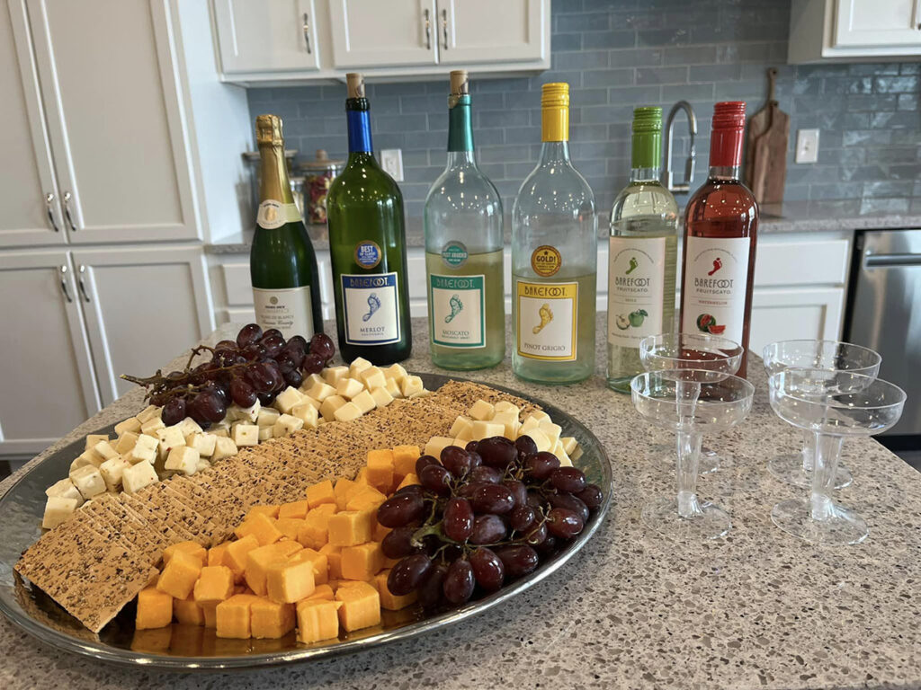 Indulge in a mouthwatering assortment of cheese, grapes, crackers, and wine, creating a delectable combination for wine and cheese enthusiasts.